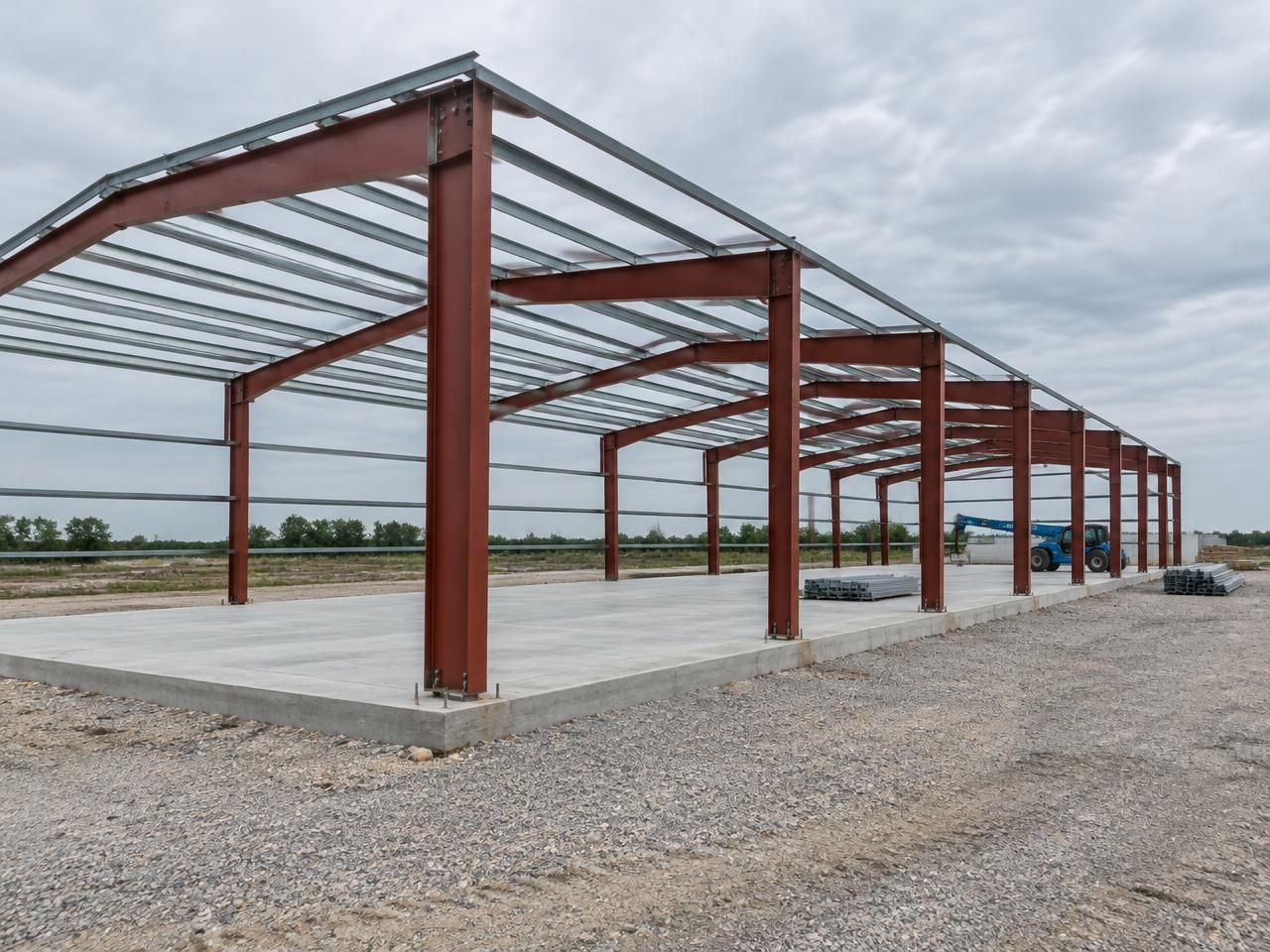 AI-generated illustration: Large red oxide steel portal frames with roof purlins at an industrial construction site. Not a completed Outlaw Building Co. project.